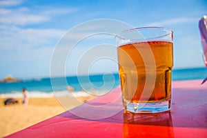 Glass of beer on the beach in Oaxaca photo