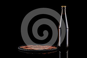 Glass beer bottle and delicious sliced sausages