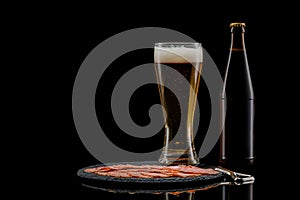 Glass beer bottle and delicious sliced sausages