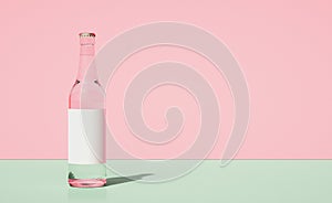 Glass beer bottle on horizontally divided bi-color retro pastel pink and green color background