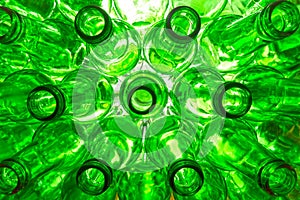 Glass beer bottles lie in rows, necks on camera