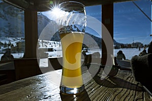 Glass of beer in cafe at ski resort in Italy, Alps