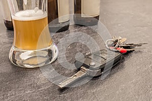 Glass of Beer and car key on grey table
