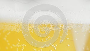 Glass of beer close-up with froth in slow motion brewery