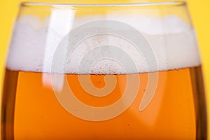 Glass of beer on color background