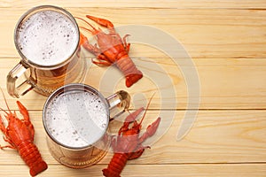 Glass beer with crawfish on light wooden background. Beer brewery concept. Beer background. top view with copy space