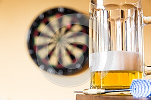 Glass of beer and dartboard