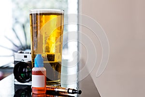 Glass of beer and gadgets on table