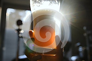 Glass of beer in the hand. Rotation of beer in a glass