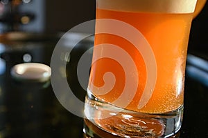 Glass of beer in the hand. Rotation of beer in a glass