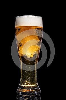 Glass of beer isolated on black background.