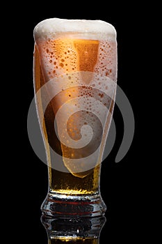 Glass of beer isolated on black background.