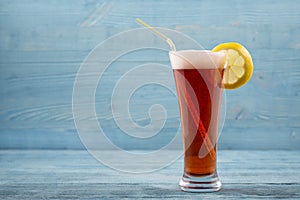 Glass of beer with lemon and sipper