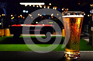 Glass of BEER on Pool Table Background