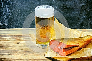 Glass with beer, smoked salmon