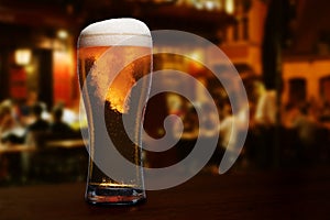 glass of beer on a street bar table,