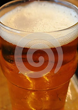 Glass of beer, thin foam. Macro shot. Ale. Alcoholic drink