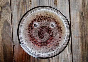 Glass of beer with two bubble and smile