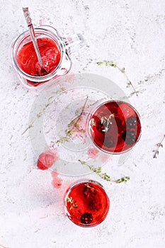 Glass of berry drink with fresh fruits on marble table