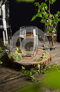 A glass of birch sap on a wooden table