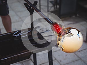 Glass-blower artist create white glass layer on transparent glass bowl photo