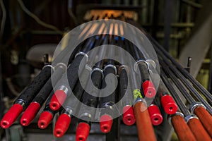 Glass blowing pipes warming up in a traditional furnace at a glass maker& x27;s workshop set up for the process