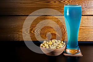 Glass with blue ale and yellow crisp