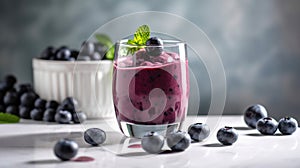 Glass of blueberry smoothie with mint and fresh berries on white marble table. Generative ai