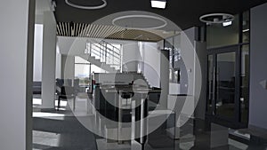 Glass border and turnstile in hall of corporate building