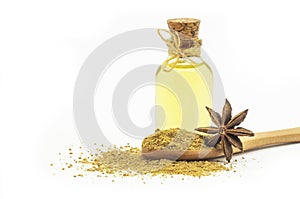 Glass bottle of anise essential oil with anise star and powder isolated on white background