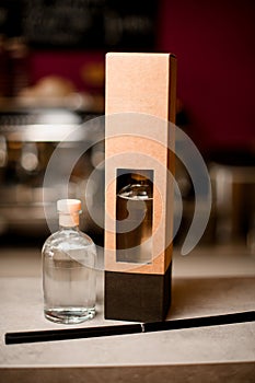 Glass bottle with aromatic oil, aroma diffuser in a box, aroma sticks