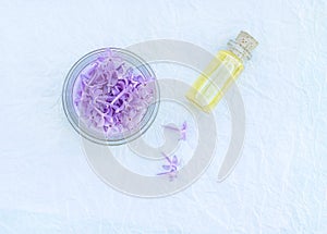Glass bottle with aromatic oil and lilac flowers for Spa and aromatherapy. Copyspace