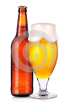 Glass and bottle of beer with drops isolated on white