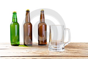 Glass and bottle of beer with no logos on wooden table isolated copy space, bottle mock up. Beer bottle studio shot with cap