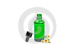 Glass bottle with chamomile essential oil isolated on white background.