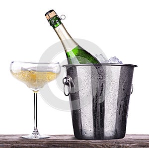 Glass and bottle of champagne in ice bucket