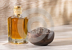 Glass bottle of chia seeds and oil - Salvia hispÃÂ¡nica photo
