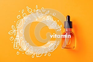 Glass bottle for cosmetics, serums and oil with vitamin C on yellow background