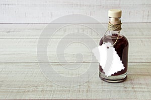 Glass bottle with a dark liquid.