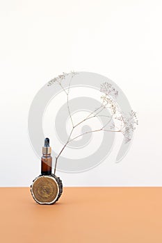 Glass bottle dropper cosmetic serum beige background photo