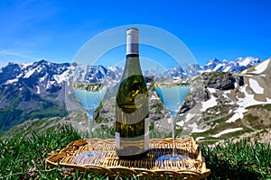 Glass and bottle of dry white Roussette de Savoie or Vin de Savoie wine from Savoy region served on Col du Galibier border Savoy