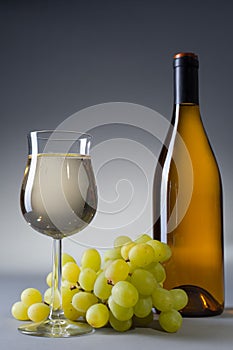 Glass and bottle full of white wine