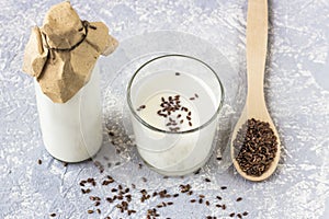 Glass bottle and glass of yogurt