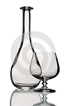 Glass bottle and goblet, isolated.