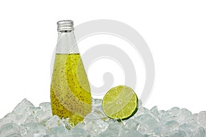 Glass bottle of green lime drink on ice