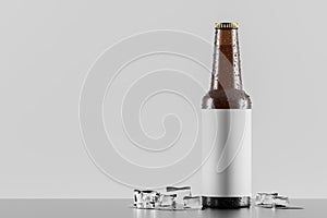 Glass bottle with ice cubes over white background