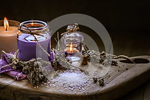 Glass bottle Lavender essential oil dried seed aromatherapy spa massage concept. herb Purple candle wood table background sea