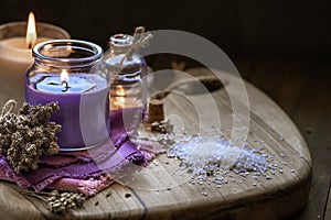 Glass bottle Lavender essential oil dried seed aromatherapy spa massage concept. herb Purple candle wood table background sea