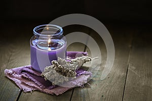 Glass bottle Lavender essential oil dried seed aromatherapy spa massage concept. herb Purple candle wood table background sea