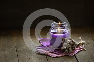 Glass bottle Lavender essential oil dried seed aromatherapy spa massage concept. herb Purple candle wood table background sea